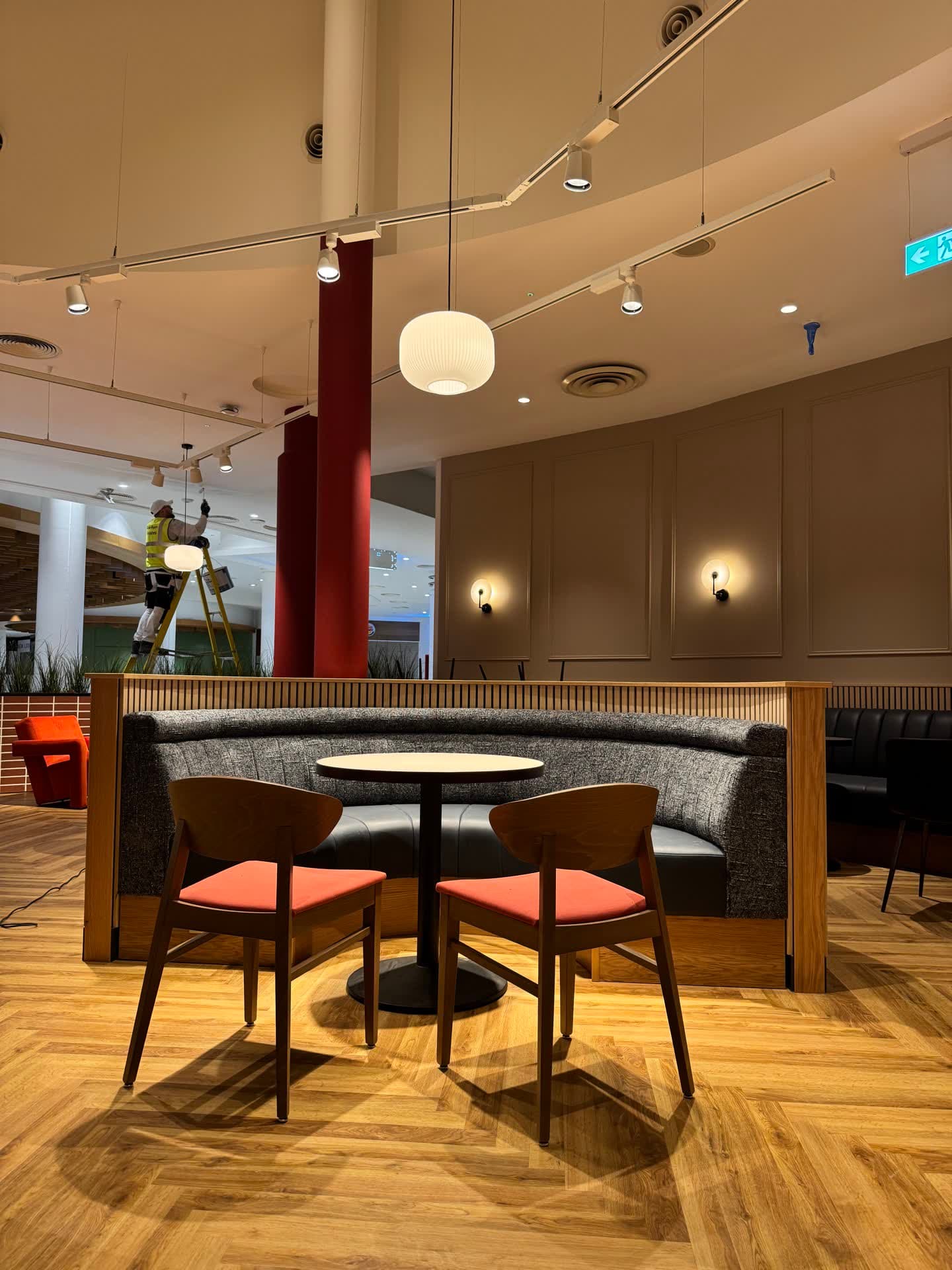 Booth seating area at Insomnia Liffey Valley with ambient wall sconces and recessed ceiling lighting