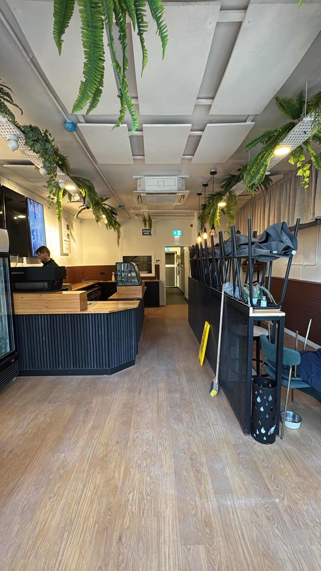 Lean Bean Coffee interior seating with recessed ceiling lights, track lighting, and emergency exit signage