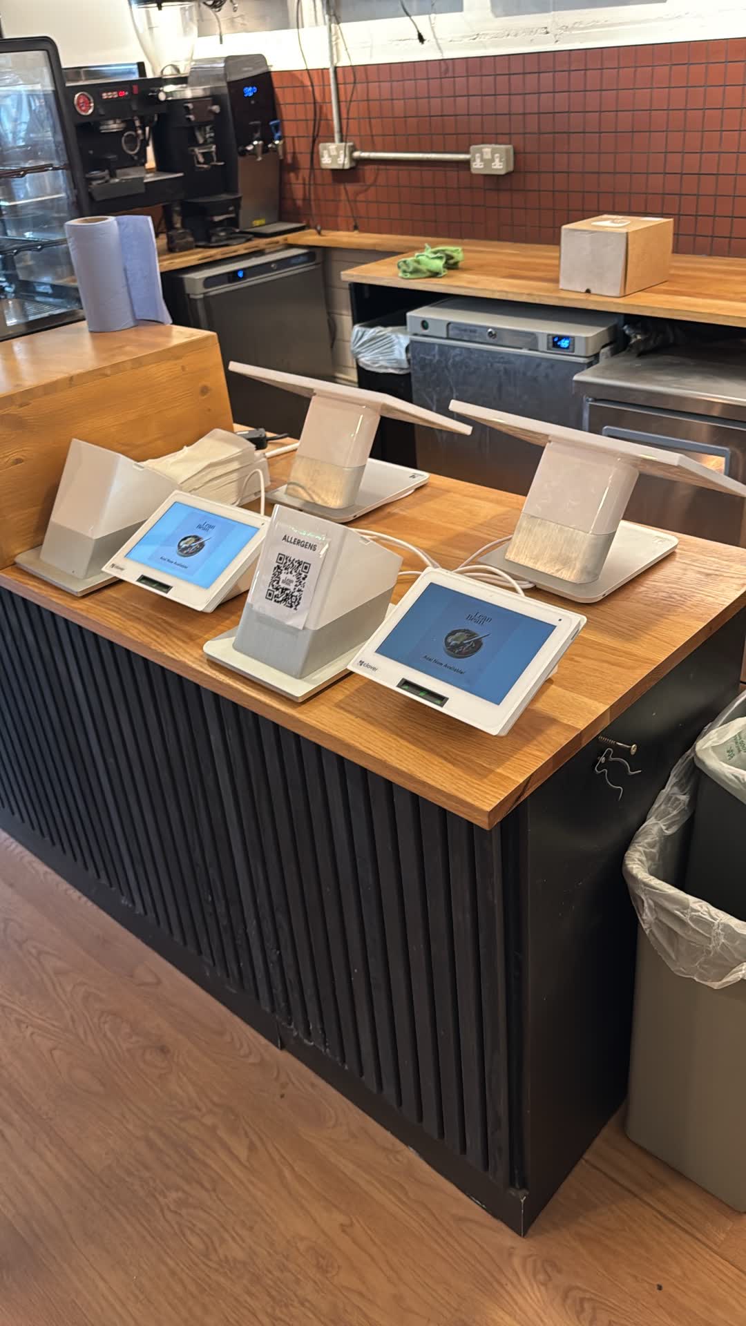 Lean Bean Coffee counter close-up showing POS tablet power supply and customer-facing charging points